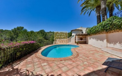 A beautiful villa in a peaceful, green setting.