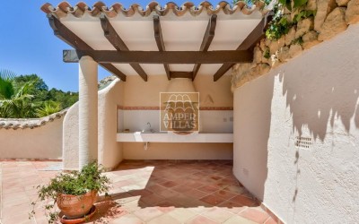 A beautiful villa in a peaceful, green setting.