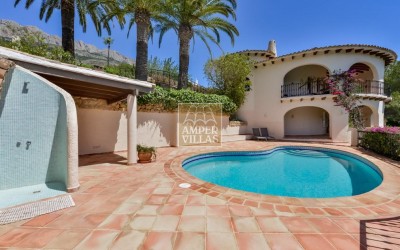 A beautiful villa in a peaceful, green setting.