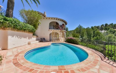 A beautiful villa in a peaceful, green setting.